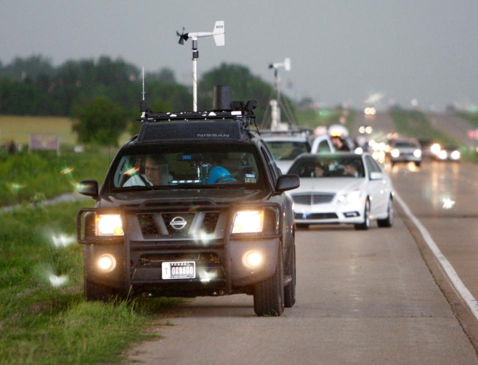 Many cars with weather instruments on top on a highway in Oklahoma