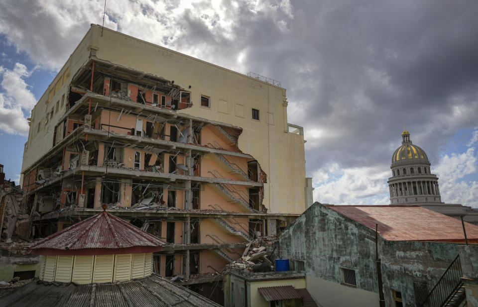 A view of the damaged Hotel Saratoga and the 19th century dome of the Calvary Baptist Church, in Old Havana, Cuba, Wednesday, May 11, 2022. The May 6th explosion that devastated the hotel and killed dozens also badly damaged Cuba's most important Baptist church, which sits next door. (AP Photo/Ramon Espinosa)