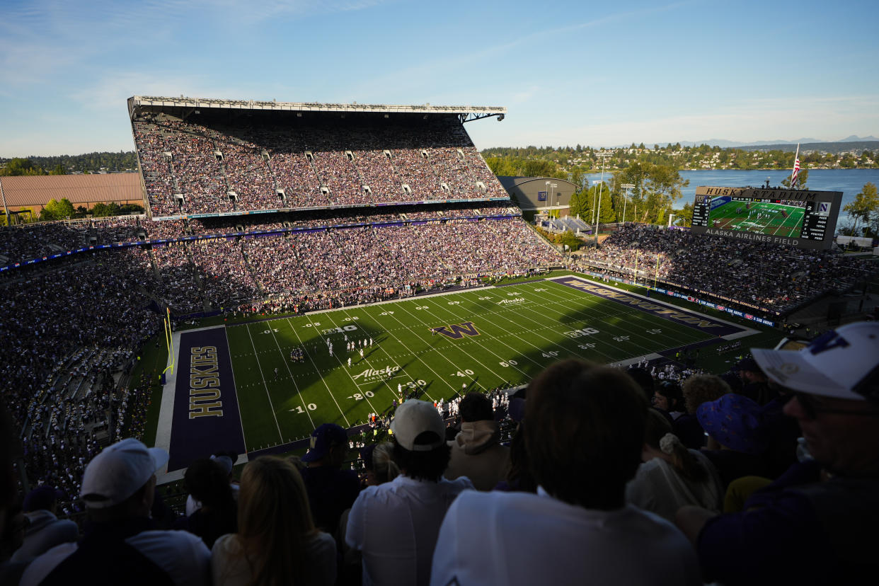 Fans watch from the upper concourse during the first half of an NCAA college football game between Washington and Northwestern, Saturday, Sept. 21, 2024, in Seattle. (AP Photo/Lindsey Wasson)