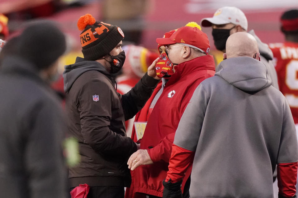 Cleveland Browns head coach Kevin Stefanski, left, talks with Kansas City Chiefs head coach Andy Reid after an NFL divisional round football game, Sunday, Jan. 17, 2021, in Kansas City. The Chiefs won 22-17. (AP Photo/Charlie Riedel)