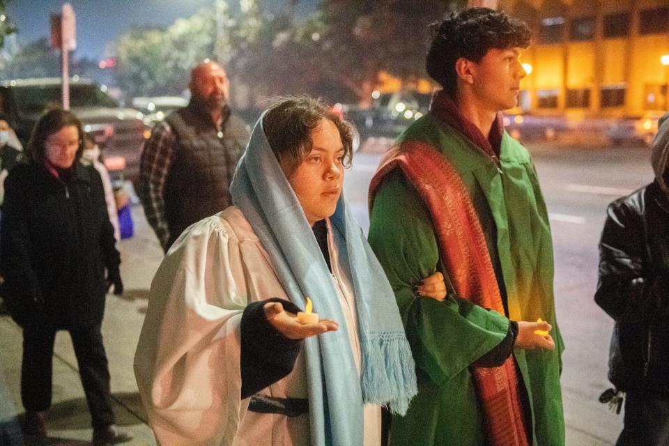 Paris Alorro, left, and her brother Jack Alorro portray Mary and Joseph as they walk with about 40 people down Center Street while participating in the Mexican Heritage Center's annual Posada procession in downtown Stockton on Friday, Dec. 23, 2022. The event reenacts Mary and Joseph's search for lodging in Bethlehem just before the birth of Jesus. The Stockton Posada went from St. Mary's Church, stopping at a few places to be symbolically turned away, to the Mexican Heritage Center where they were welcomed in. 