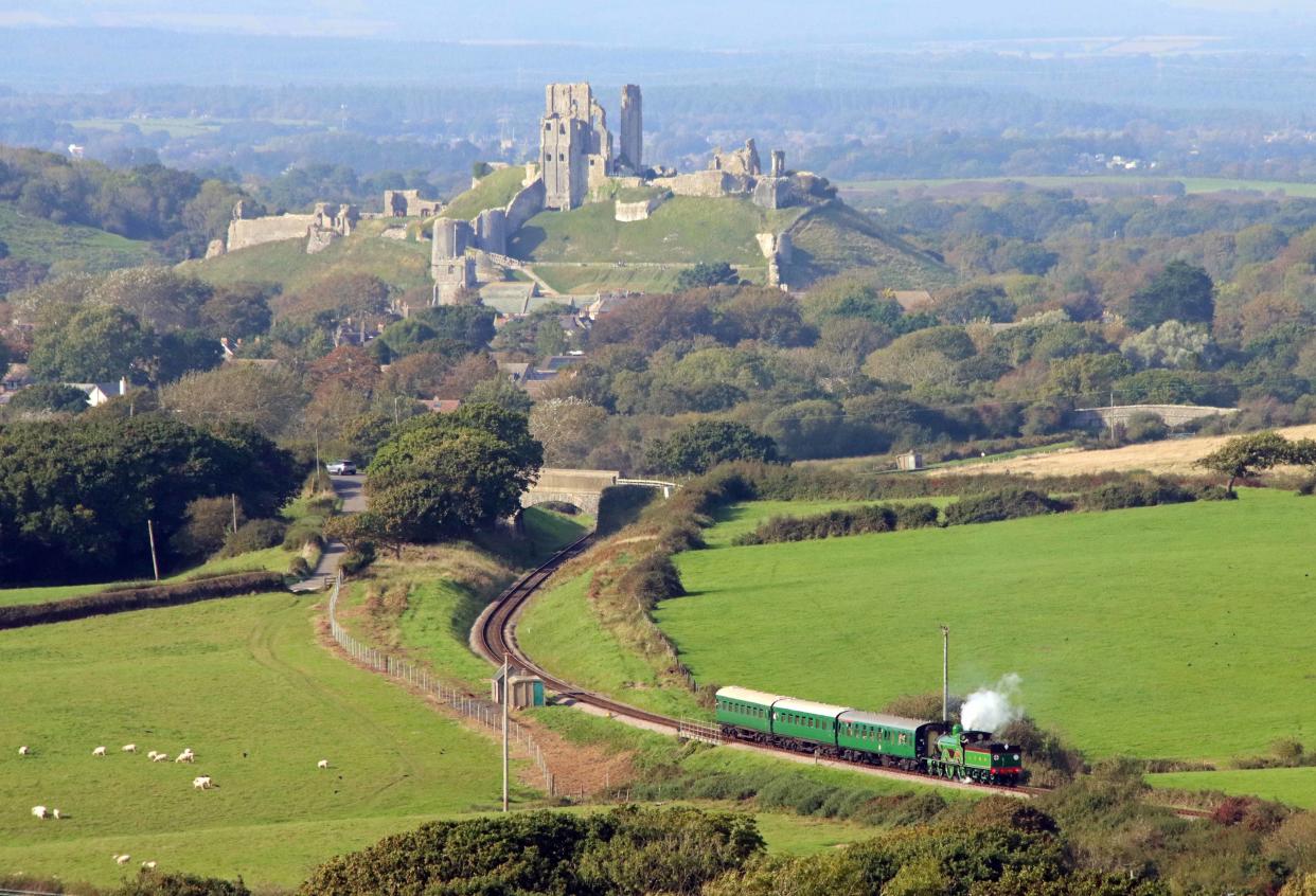 The locomotive running with Corfe Castle in the background