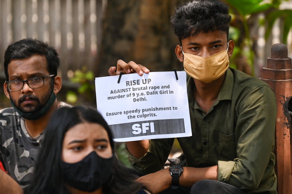 Activists hold placards to protest the alleged rape and murder of a nine-year-old girl in New Delhi on 4 August. In 2020, India registered at least 43,000 cases under the Pocso Act (AFP via Getty Images)