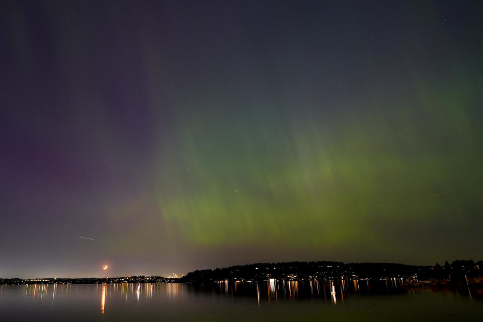 The northern lights, or aurora borealis, can be seen over Lake Washington in Renton, Washington on Friday evening, May 10, 2024.  / Credit: Lindsey Wasson / AP