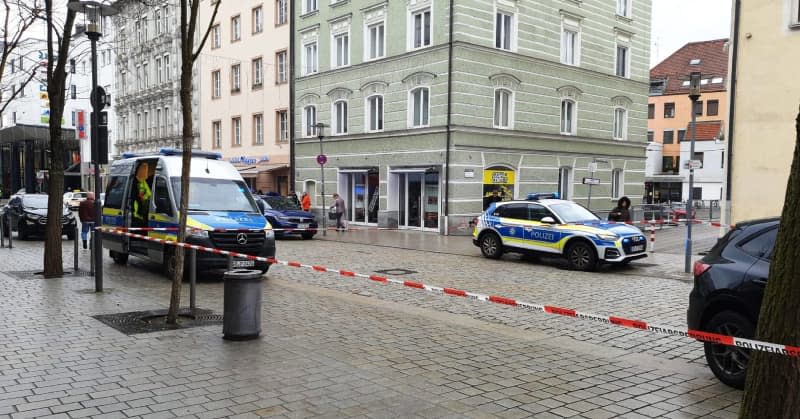 Police officers work at the scene in the city center after a truck has driven into a group of pedestrians in Passau city center, injuring several people and killing one woman. The lorry driver is also on his way to hospital, said a police spokesman. -/Zema Medien/dpa