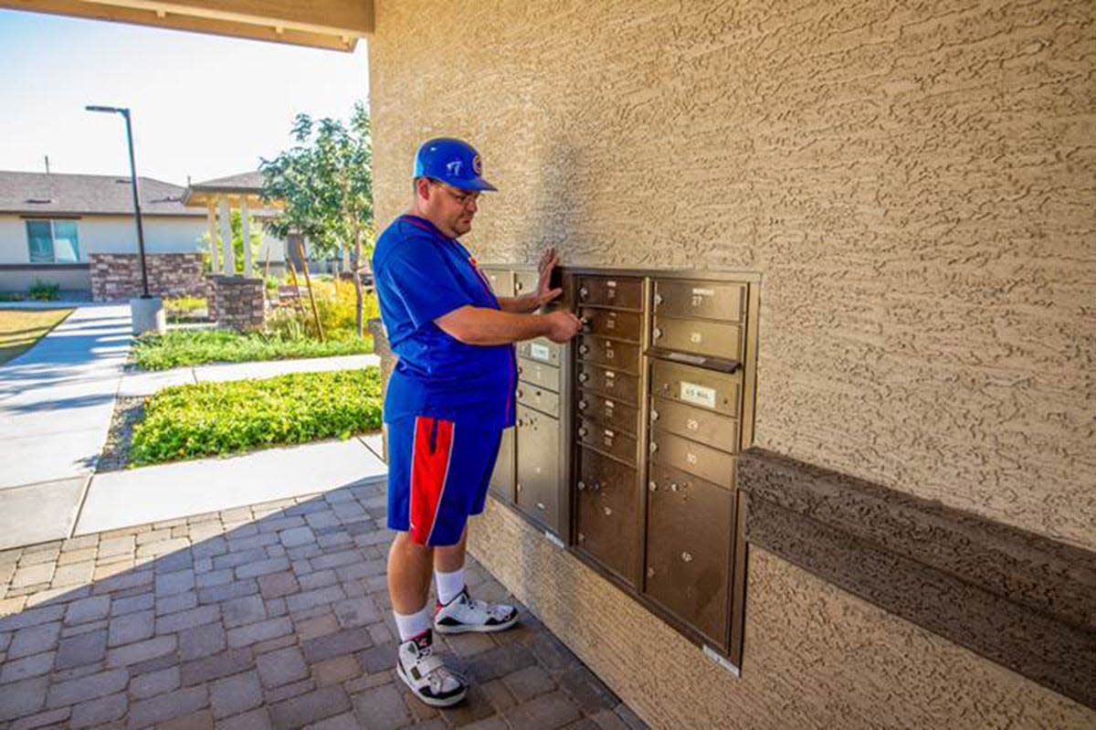 A resident gets his mail at Spectrum Courtyard Apartments in Phoenix. The property was developed by the Foundation for Senior Living, which sets aside 25% of its units for individuals with autism.