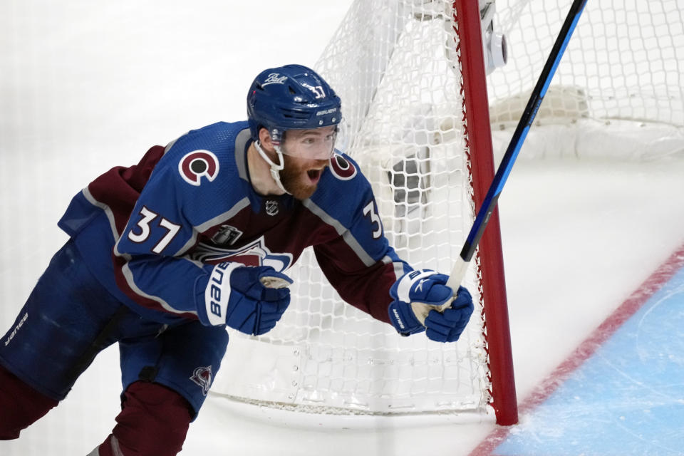 Colorado Avalanche left wing J.T. Compher (37) celebrates after an overtime goal from Andre Burakovsky against the Tampa Bay Lightning during Game 1 of the NHL hockey Stanley Cup Final on Wednesday, June 15, 2022, in Denver. (AP Photo/David Zalubowski)