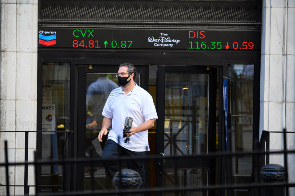 NEW YORK, NEW YORK - AUGUST 03: A person walks out of the New York Stock Exchange as the city continues Phase 4 of re-opening following restrictions imposed to slow the spread of coronavirus on August 3, 2020 in New York City. The fourth phase allows outdoor arts and entertainment, sporting events without fans and media production. (Photo by Noam Galai/Getty Images)