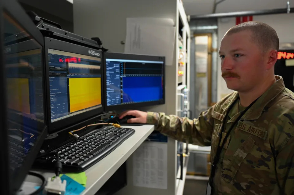 A member of the 16th Electronic Warfare Squadron, another unit with the 350th Spectrum Warfare Wing, analyzes radio frequency signals at the B-1 Lab at Eglin Air Force Base in Florida. (This photo has been altered for security purposes by blurring out portions of monitors). <em>USAF</em>