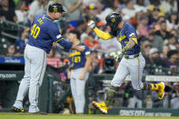 Milwaukee Brewers' Joey Ortiz, right, celebrates his three-run home run against the Houston Astros with third base coach Jason Lane during the fourth inning of a baseball game Friday, May 17, 2024, in Houston. (AP Photo/Eric Christian Smith)