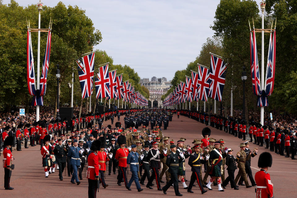 <p>Member of the armed forces march along The Mall in ceremonial procession after the Queen's state funeral. (PA)</p> 