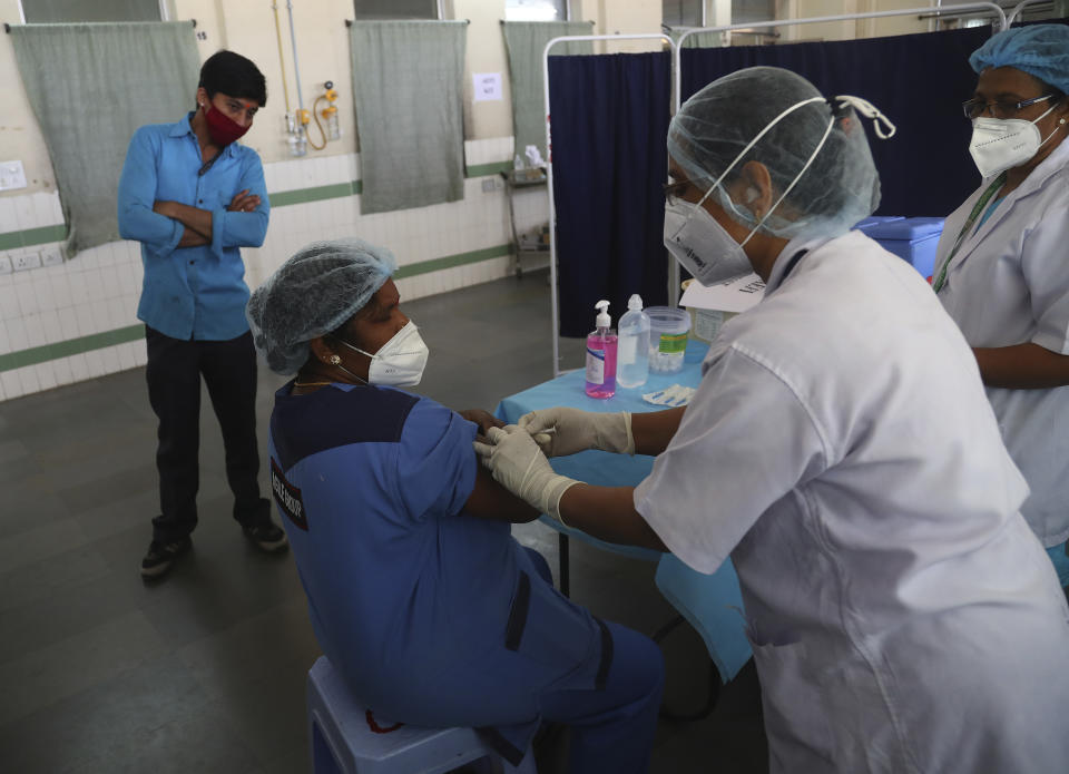 Health workers participate in a COVID-19 vaccine delivery system trial in Hyderabad, India, Saturday, Jan. 2, 2021. India tested its COVID-19 vaccine delivery system with a nationwide trial on Saturday as it prepares to roll-out an inoculation program to stem the coronavirus pandemic. Saturday's exercise included necessary data entry into an online platform for monitoring vaccine delivery, along with testing of cold storage and transportation arrangements for the vaccine, the health ministry had said.(AP Photo/Mahesh Kumar A.)