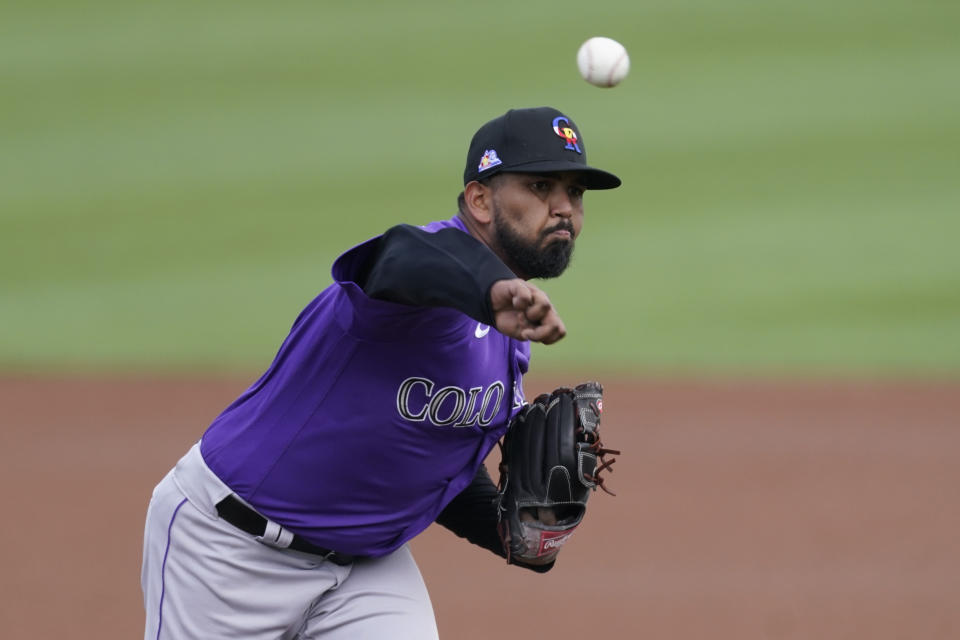 Colorado Rockies starting pitcher German Marquez (48) throws during the first inning of a spring training baseball game against the San Francisco Giants Friday, March 12, 2021, in Scottsdale, Ariz. (AP Photo/Ashley Landis)