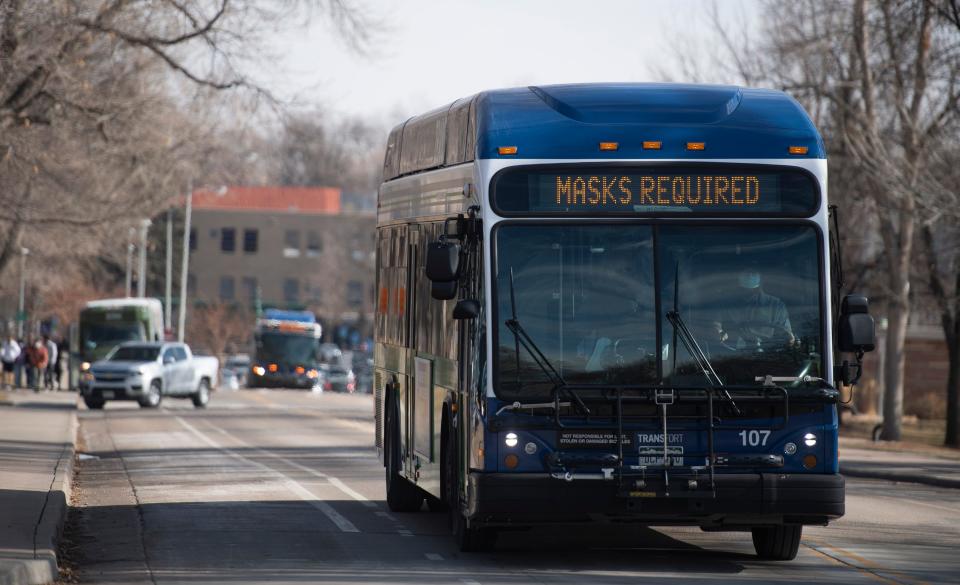 An electronic sign on the front of a Transfort bus reads "masks required" as it drives through the Colorado State University campus in Fort Collins a year ago.