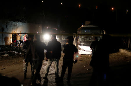 Police officers inspect a scene of a bus blast in Giza, Egypt, December 28, 2018. REUTERS/Amr Abdallah Dalsh