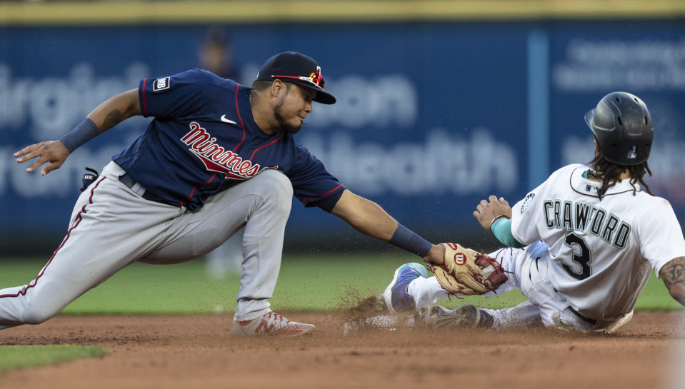 Minnesota Twins second baseman Luis Arraez tags out Seattle Mariners' J.P. Crawford on an attempted steal of second base during the fourth inning of a baseball game Wednesday, June 16, 2021, in Seattle. Crawford was originally called safe, but after a challenge he was ruled out. (AP Photo/Stephen Brashear)