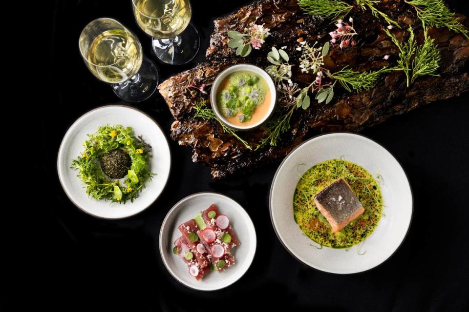 The Elderberry House restaurant in Oakhurst shows off food from its new three-course $95 menu, including from left, a salad called Kern Farm’s Weeds, ahi tuna, steelhead trout and sea urchin and spring peas starter. It’s all served on bark foraged from nearby.