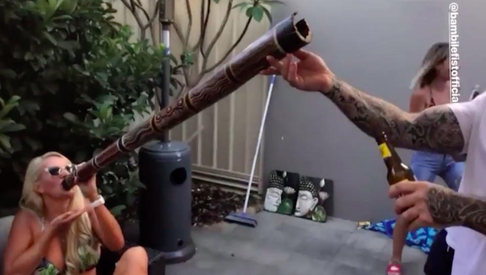 The adult entertainer sees off the full beer through the didgeridoo. Source: Instagram/ Cassy Walker