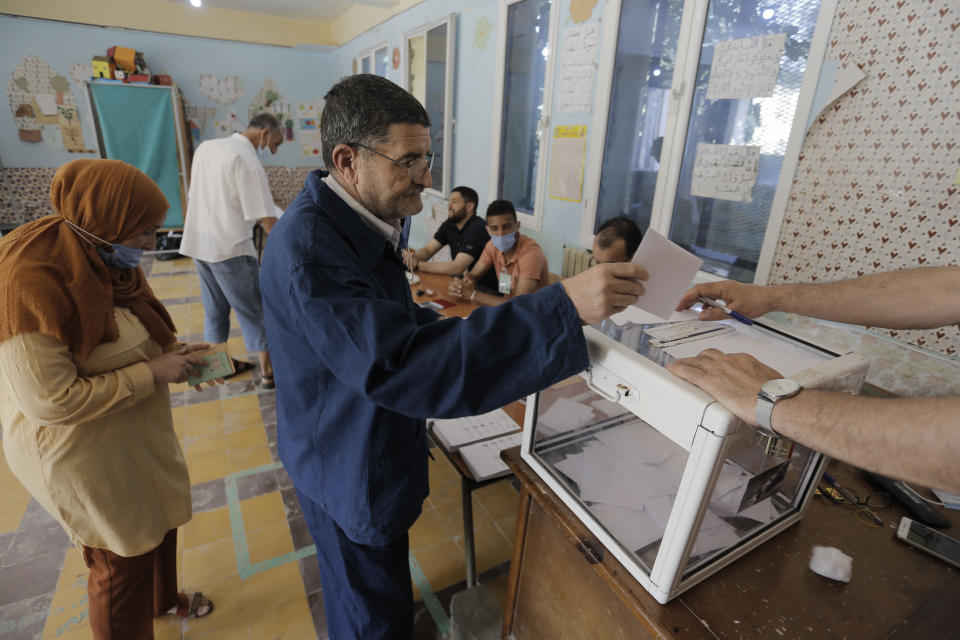 Algerians cast their vote in the country's first legislative elections sine the ouster of ex-president Bouteflika, in Algiers, Algeria, Saturday, June 12, 2021. Algerians vote Saturday for a new parliament in an election with a majority of novice independent candidates running under new rules meant to satisfy demands of pro-democracy protesters and open the way to a "new Algeria." (AP Photo/Toufik Doudou)