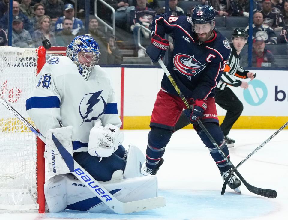 Feb. 10, 2024; Columbus, Ohio, USA; 
A puck strikes Tampa Bay Lightning goaltender Andrei Vasilevskiy (88) as he defends the goal from Columbus Blue Jackets center Boone Jenner (38) during the third period of a hockey game at Nationwide Arena on Saturday.