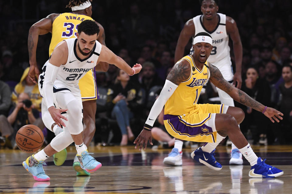 Memphis Grizzlies guard Tyus Jones, left, takes the ball after Los Angeles Lakers guard Kentavious Caldwell-Pope loses control of it during the first half of an NBA basketball game Friday, Feb. 21, 2020, in Los Angeles. (AP Photo/Mark J. Terrill)