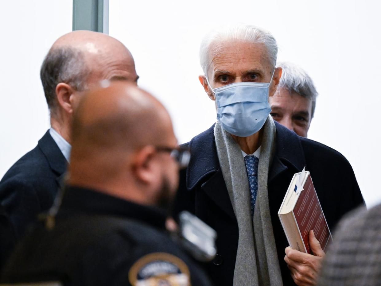 Former Quebec Court of Appeal judge Jacques Delisle leaves the courtroom for a recess on March 14, 2024 in Quebec City. Delisle pleaded guilty to manslaughter in his wife's death and was sentenced to one additional day in jail.  (Jacques Boissinot/The Canadian Press - image credit)