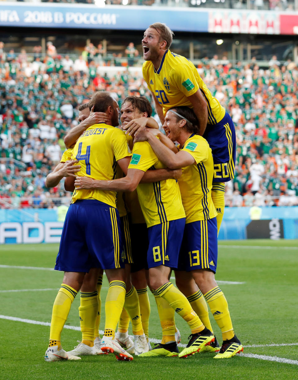 <p>Andreas Granqvist celebrates scoring their second goal from the spot with his team mates </p>