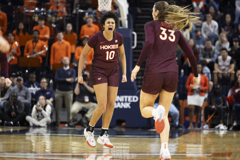 Virginia Tech's Carys Baker (10) celebrates after Elizabeth Kitley (33) made a basket during the first half of an NCAA college basketball game against Virginia, Sunday, March. 3, 2024, in Charlottesville, Va. (AP Photo/Mike Kropf)