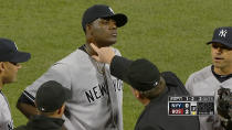 In this April 23, 2014 photo taken from video and provided by ESPN, home plate umpire Gerry Davis touches the neck of New York Yankees starting pitcher Michael Pineda in the second inning of the Yankees' baseball game against the Boston Red Sox at Fenway Park in Boston. Pineda was ejected after umpires found a foreign substance on his neck. (AP Photo/ESPN)