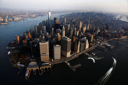 The rising sun lights One World Trade as it stands over the Manhattan borough of New York. REUTERS/Lucas Jackson