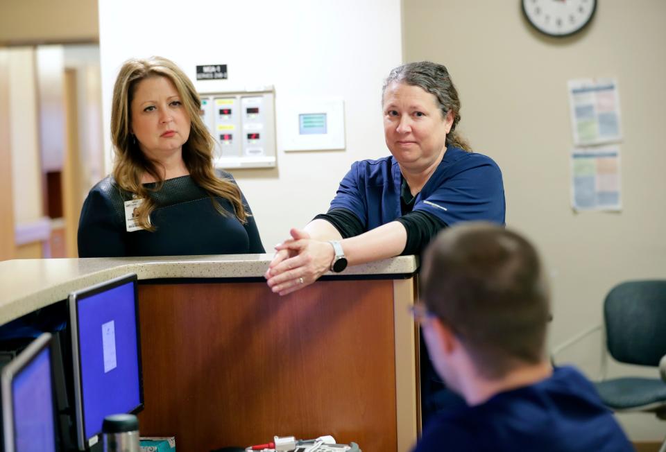 President Katherine Vergos, left, and manager Wendy Hoepner talk with Christopher Johnson, RN, about what it was like to work at 5 South, the COVID unit at SSM St. Agnes Hospital earlier this year in Fond du Lac. Vergos stops by to talk to the nurses on a regular basis.