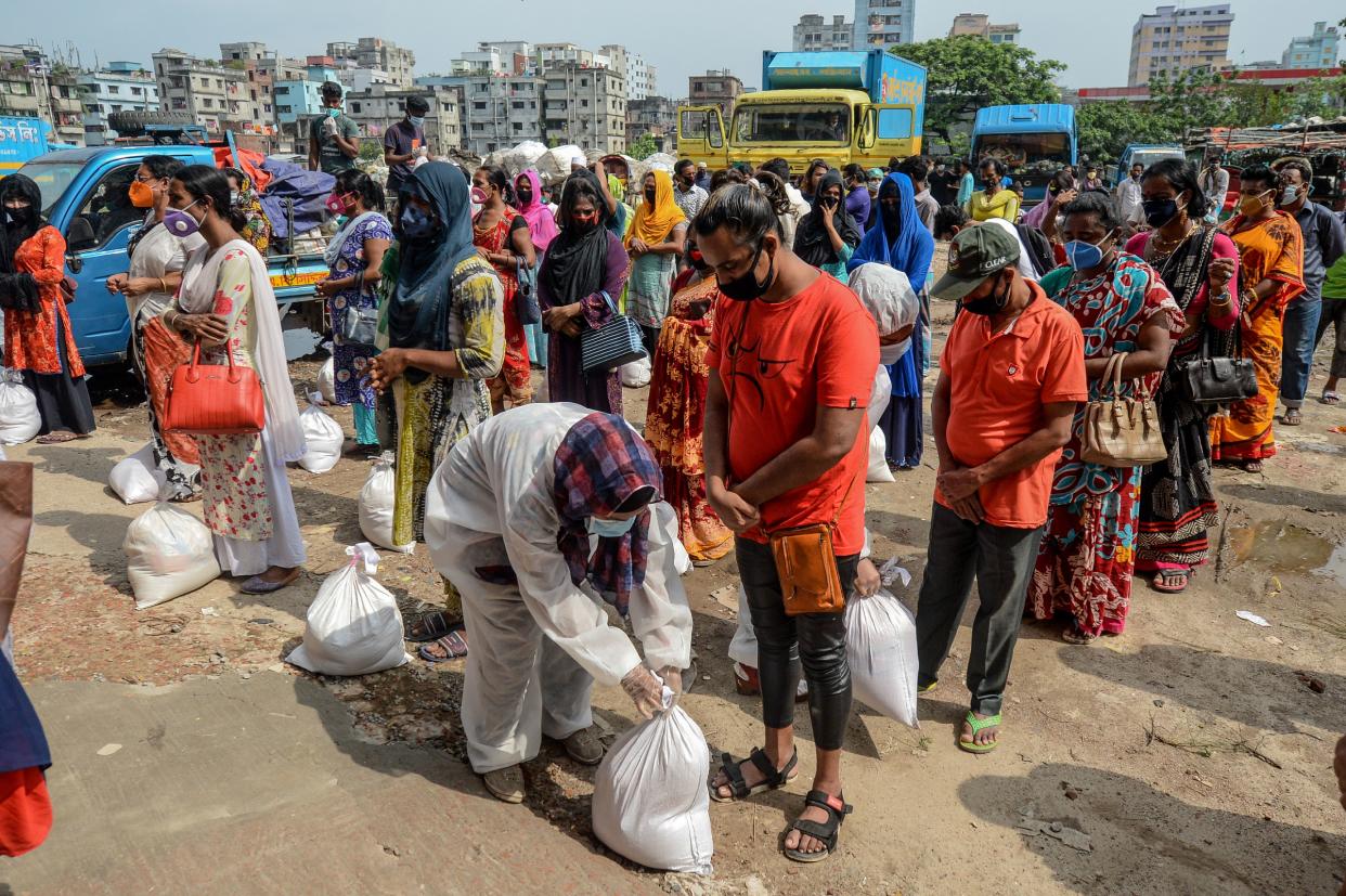 Transgender people wait standing to collect relief material during a government-imposed lockdown as a preventive measure against the COVID-19 coronavirus, in Dhaka on May 6, 2020. (Photo by MUNIR UZ ZAMAN / AFP) (Photo by MUNIR UZ ZAMAN/AFP via Getty Images)