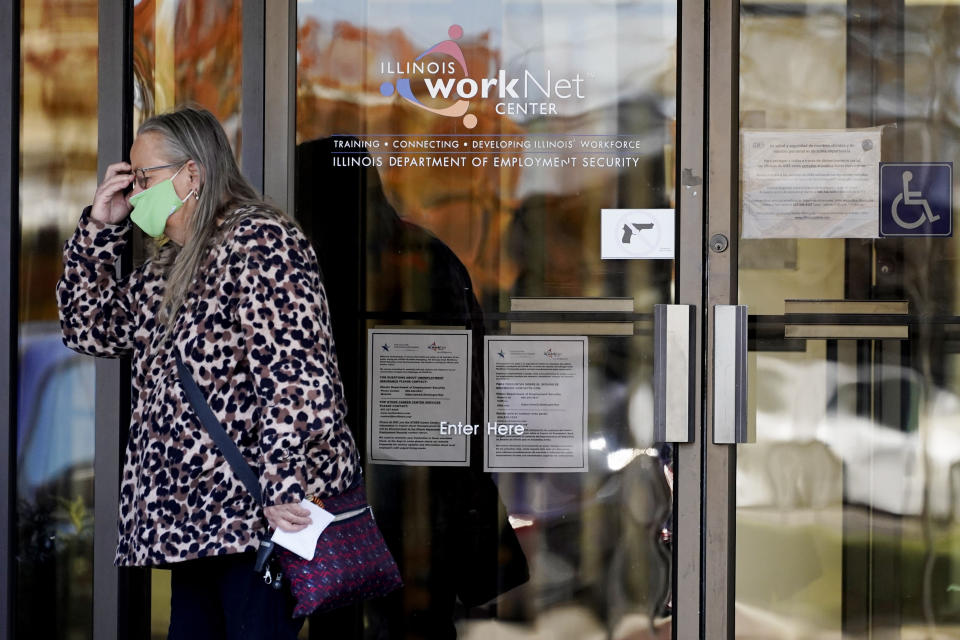 A woman reacts as she leaves after she checked information signs at IDES (Illinois Department of Employment Security) WorkNet center in Arlington Heights, Ill., Thursday, Nov. 5, 2020. Illinois reports biggest spike in unemployment claims of all states. (AP Photo/Nam Y. Huh)