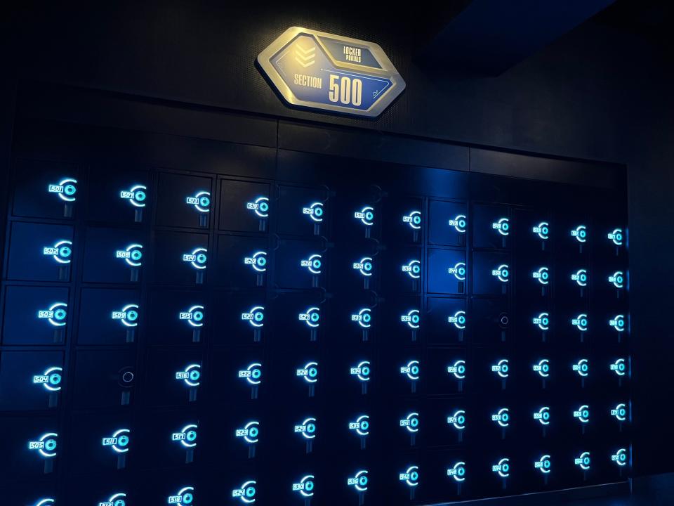 rows of lockers inside the queue for the tron roller coaster at disney world