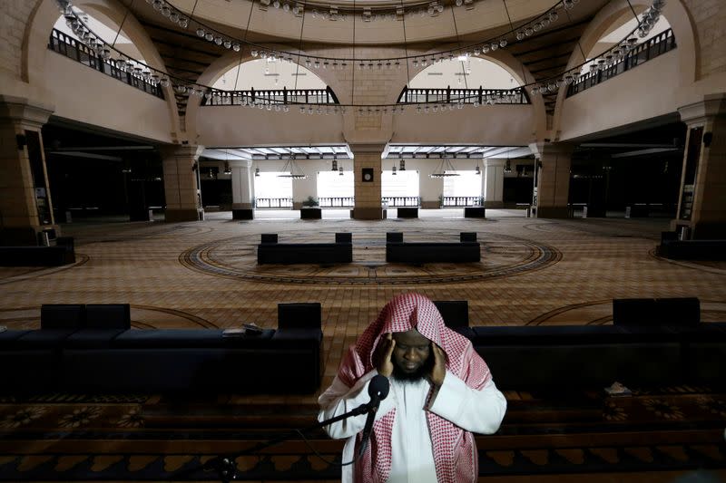 FILE PHOTO: A cleric calls for the prayer at an empty Al-Rajhi Mosque, as Friday prayers were suspended following the spread of the coronavirus disease (COVID-19), in Riyadh