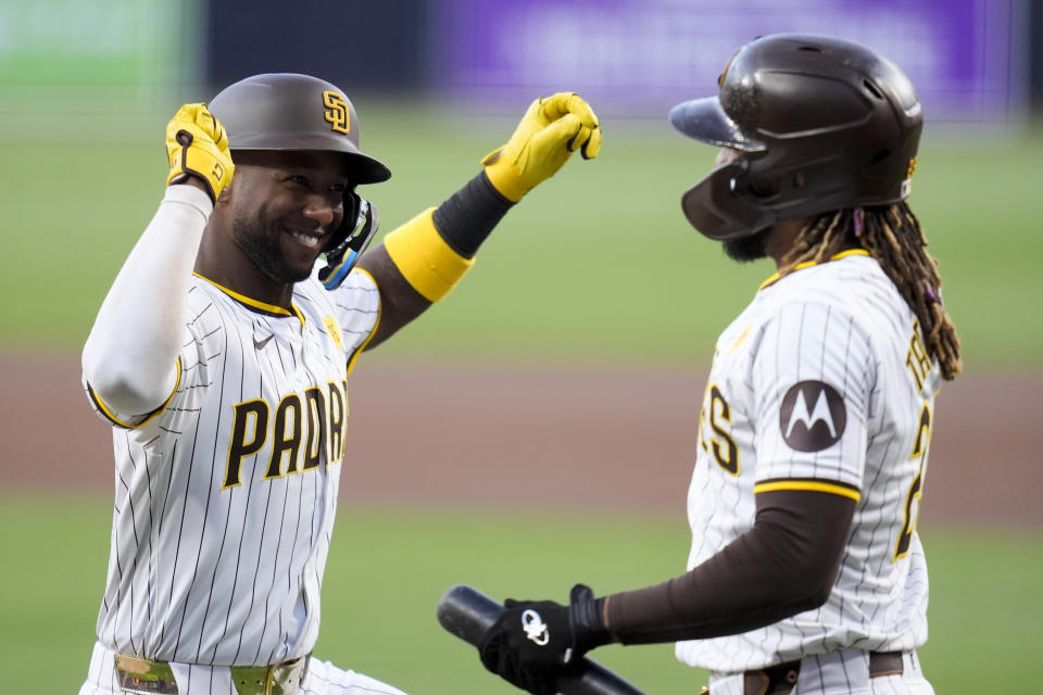 San Diego Padres' Jurickson Profar, left, celebrates with teammate Fernando Tatis Jr. after hitting a home run during the first inning of a baseball game against the Cincinnati Reds, Monday, April 29, 2024, in San Diego. (AP Photo/Gregory Bull)