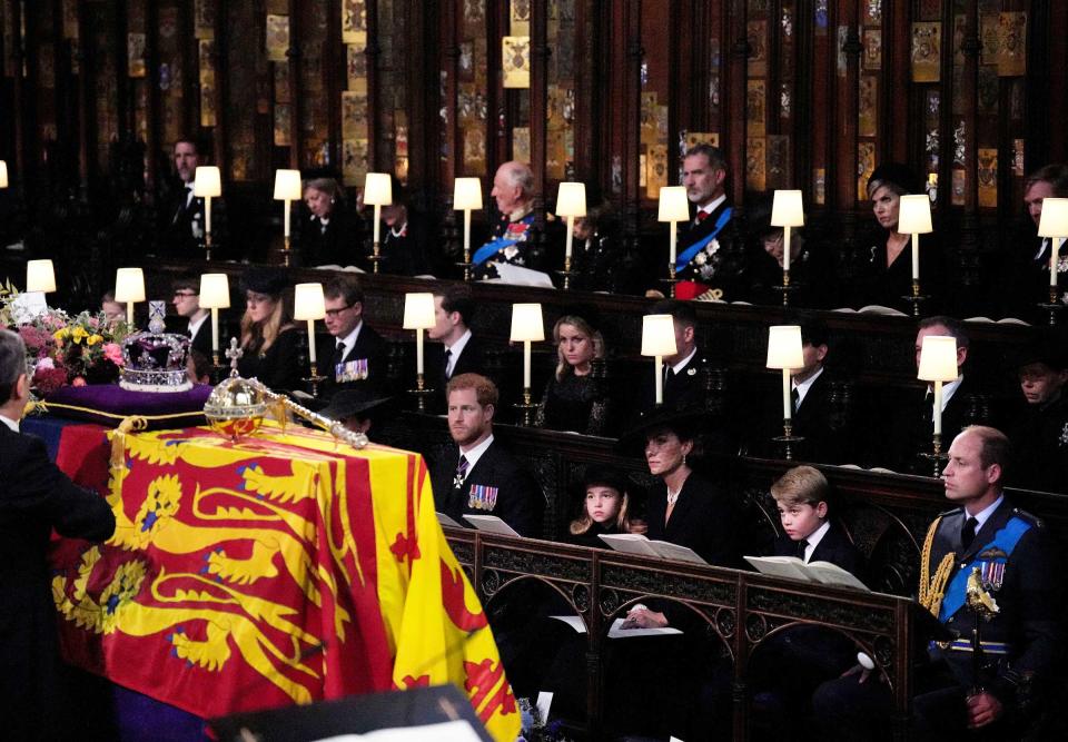 Members of the royal family watch as the Imperial State Crown and the Sovereign's orb and sceptre are removed from the coffin of Queen Elizabeth II, draped in the Royal Standard, during the Committal Service at St George's Chapel on September 19, 2022 in Windsor, England.<span class="copyright">Victoria Jones—WPA Pool/Getty Images</span>