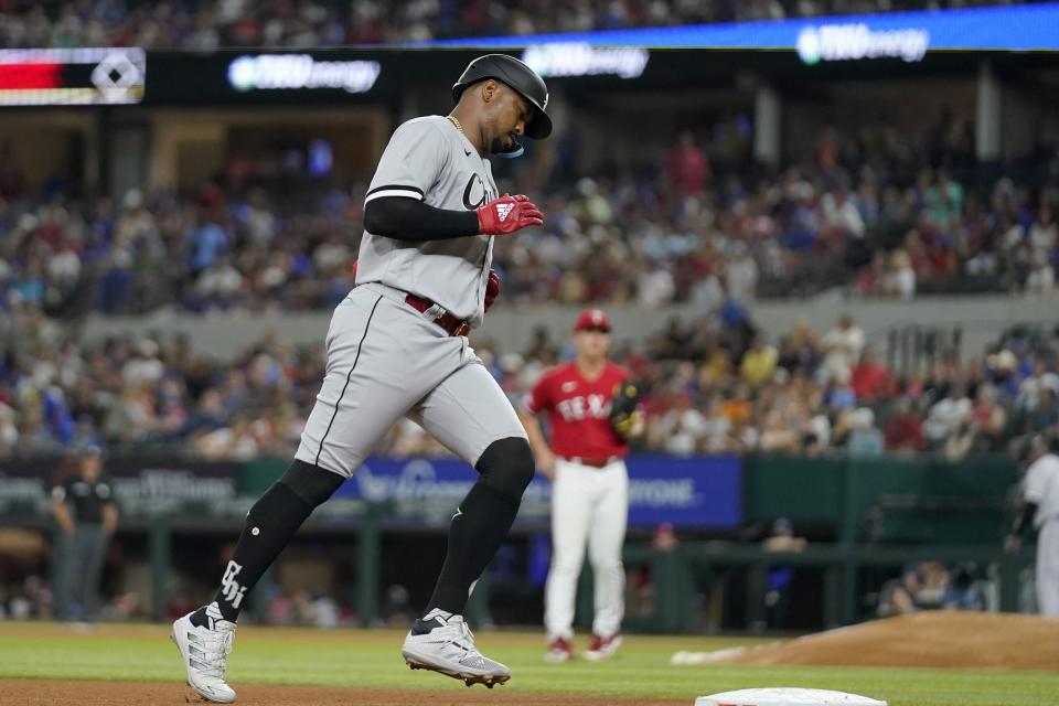 Chicago White Sox's Eloy Jimenez runs the bases after hitting a solo home run off Texas Rangers starting pitcher Glenn Otto, rear, during the fourth inning of a baseball game Friday, Aug. 5, 2022, in Arlington, Texas. (AP Photo/Tony Gutierrez)