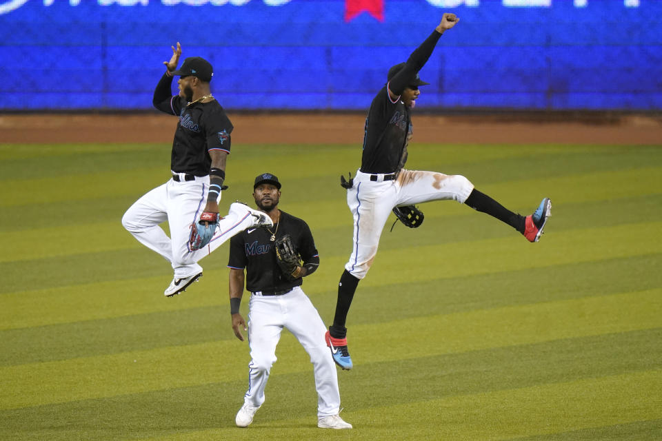 Miami Marlins' Monte Harrison, left, Starling Marte, center, and Lewis Brinson celebrate after the team's baseball game against the Washington Nationals, Saturday, Sept. 19, 2020, in Miami. The Marlins won 7-3. (AP Photo/Lynne Sladky)