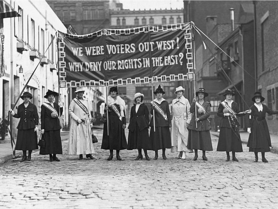 Suffragists displaying banners in Greenwich Village, New York City, in 1912.