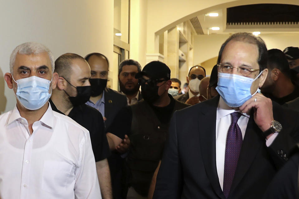 Yehiyeh Sinwar, left, the top Hamas leader in Gaza, and the head of the Egyptian General Intelligence Abbas Kamel, right, walk as they meet in Gaza Monday, May 31, 2021. (Mohammed Salem/Pool Photo via AP)