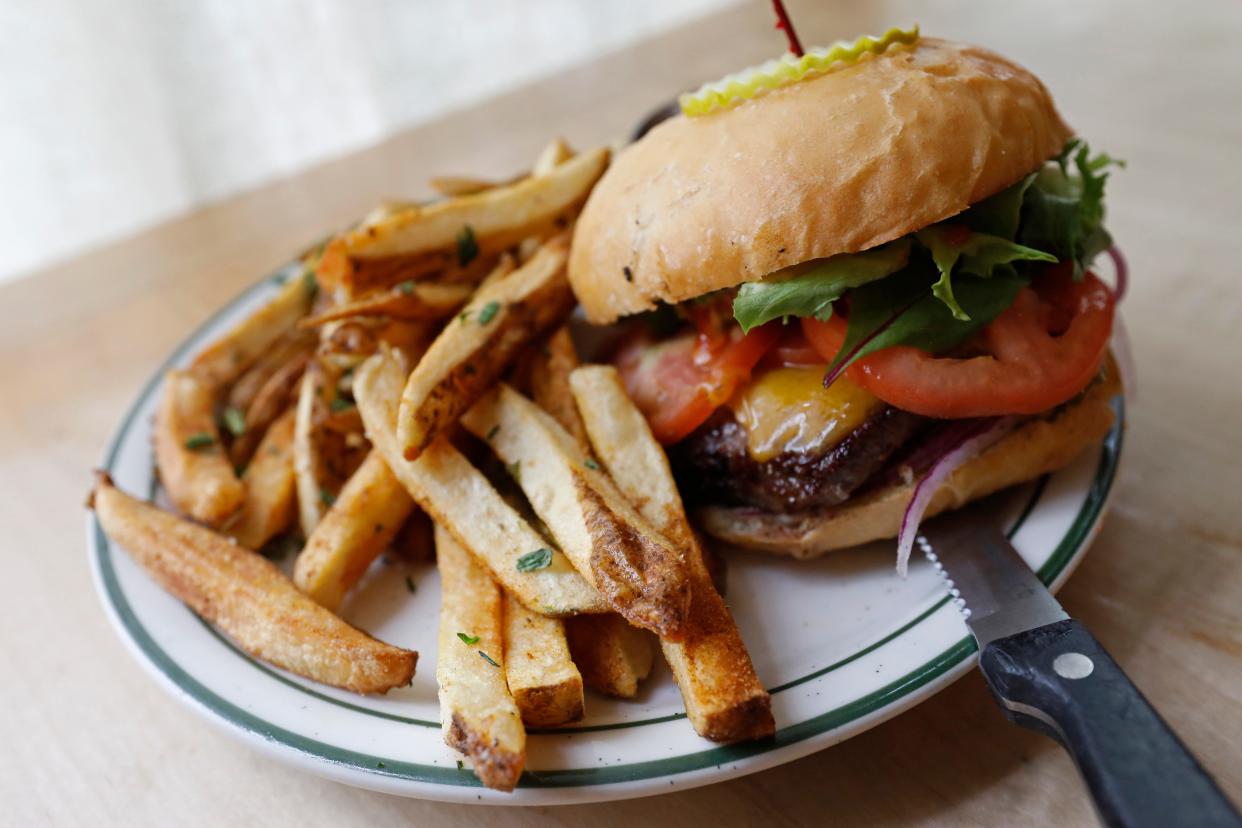 The Big City burger from Big City Bread. Painted Hill Farm all natural beef and topped with the classic cheddar, lettuce, tomato, red onion and pickles with fresh hand cut fries.