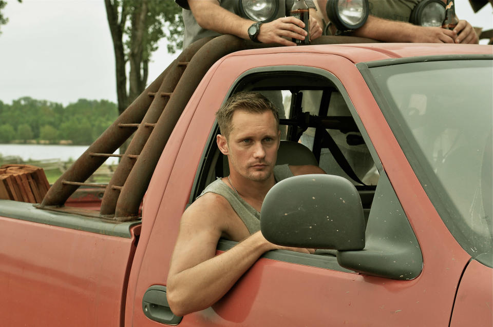 Alexander Skarsgard leans out a truck's window