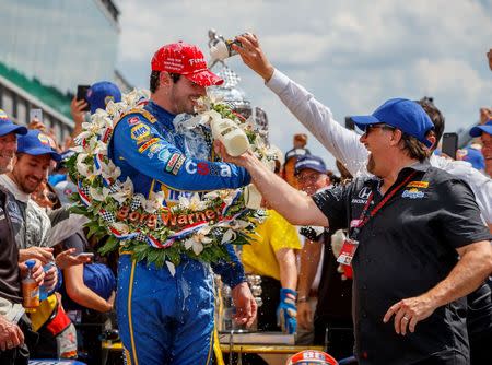 May 29, 2016; Indianapolis, IN, USA; IndyCar Series driver Alexander Rossi (left) is doused with milk by team owner Michael Andretti as they celebrate after winning the 100th running of the Indianapolis 500 at Indianapolis Motor Speedway. Mandatory Credit: Mark J. Rebilas-USA TODAY Sports
