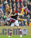 <p>West Ham United’s Andy Carroll, left and Hull City’s Harry Maguire battle for the ball </p>