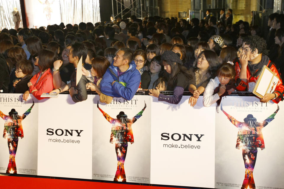 FILE - In this Oct. 28, 2009 file photo, Michael Jackson's fans wait before the premiere of "Michael Jackson's This is it" in Tokyo, Japan. Jurors hearing a case filed by Katherine Jackson over her son Michael’s death have received a behind-the-scenes look at the superstar’s troubles off-camera as he prepared for his ill-fated comeback shows. The panel was reminded on Thursday, Aug. 8, 2013, of statements describing the “Thriller" singer as deteriorating and slow to pick up material for the shows that would heavily feature the hits that made him famous, but defense attorneys for concert promoter AEG Live LLC say the “This Is It” footage is an accurate portrayal of his preparations and doesn’t show Jackson in decline. (AP Photo/Shizuo Kambayashi, File)