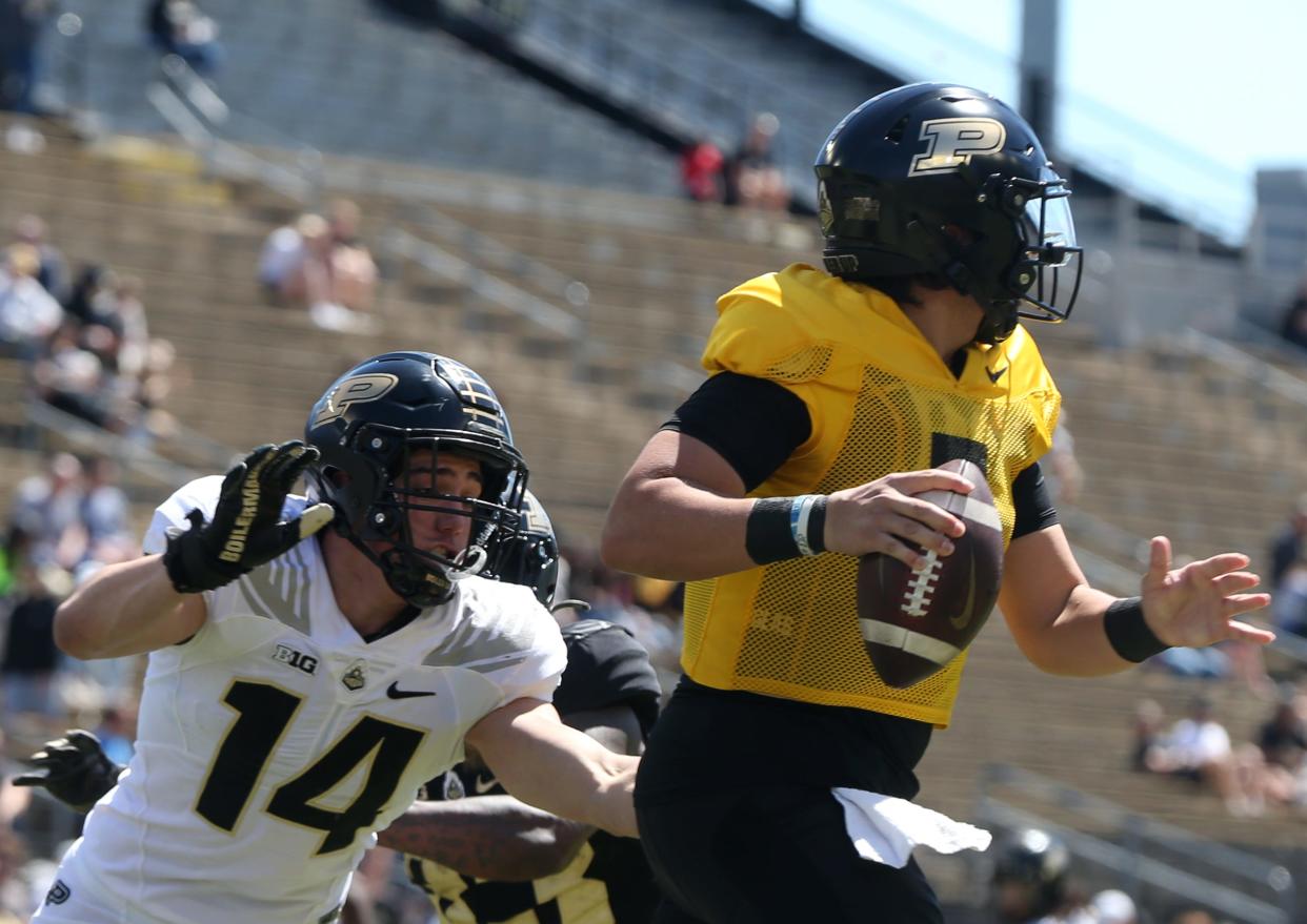 Purdue Boilermakers linebacker Yanni Karlaftis (14) rushes Purdue Boilermakers quarterback Marcos Davila (5) during the spring football game, Saturday, April 13, 2024, at Ross-Ade Stadium in West Lafayette, Ind.