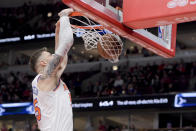 New York Knicks' Isaiah Hartenstein (55) dunks during the first quarter of an NBA basketball game against the Chicago Bulls in Chicago, Friday, April 5, 2024. (AP Photo/Mark Black)