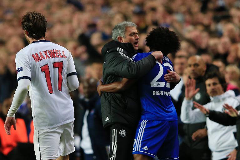 Chelsea's manager Jose Mourinho (C) embraces midfielder Willian (R) on the touchline during their UEFA Champions League quarter-final second leg match against Paris Saint-Germain, at Stamford Bridge in London, on April 8, 2014