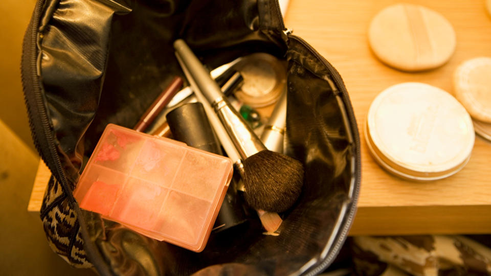 Makeup Bag and Cosmetics on Tabletop. Photo: Getty Images.